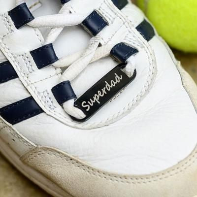 Branded Promotional BLACK STAINLESS STEEL METAL TRAINER TAG Shoes From Concept Incentives.